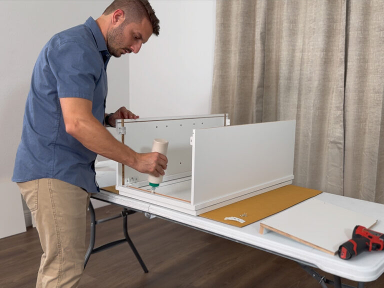 Homeowner assembling an RTA kitchen cabinet from Simply Cabinets.